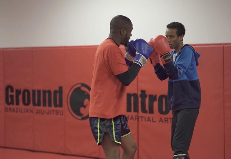 Two martial arts students sparring with punching gloves
