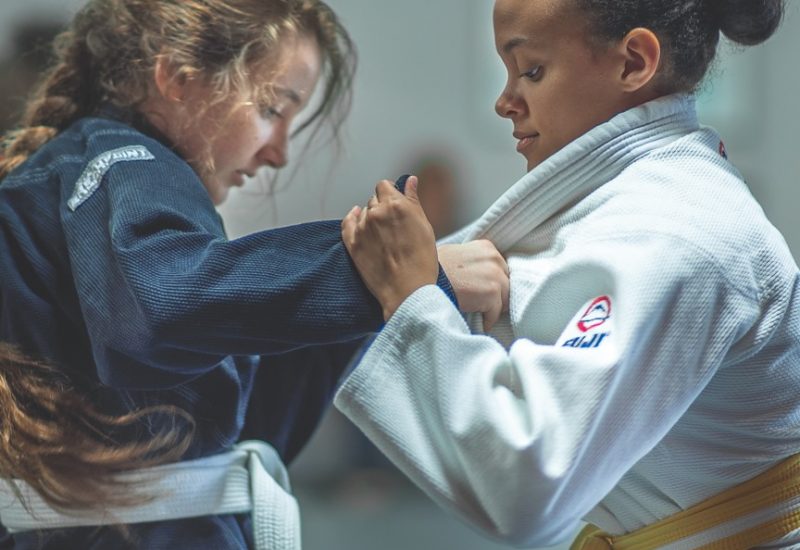 Two women grappling with each other in a women's martial arts class